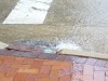 Water rushing in the street at City Hall, the corner of S. Huron and Michigan