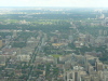 The green lawn just below the center is Queen's Park (on the campus of U of T). In the middle of Queen's Park is the Ontario Parliament